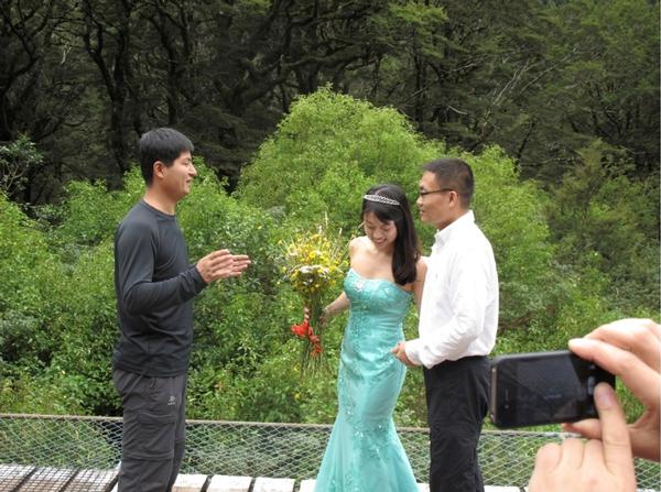 The happy wedding couple with their friend Qaio Xinyu.